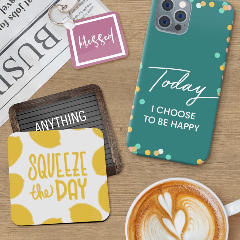 Coasters, keyring and a phone case laying on a desk with a newspaper and coffee mug
