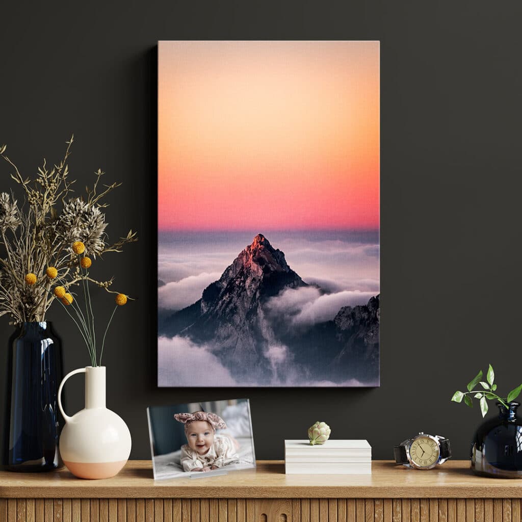Canvas print hanging on a wall in front of a table display with an acrylic photo print